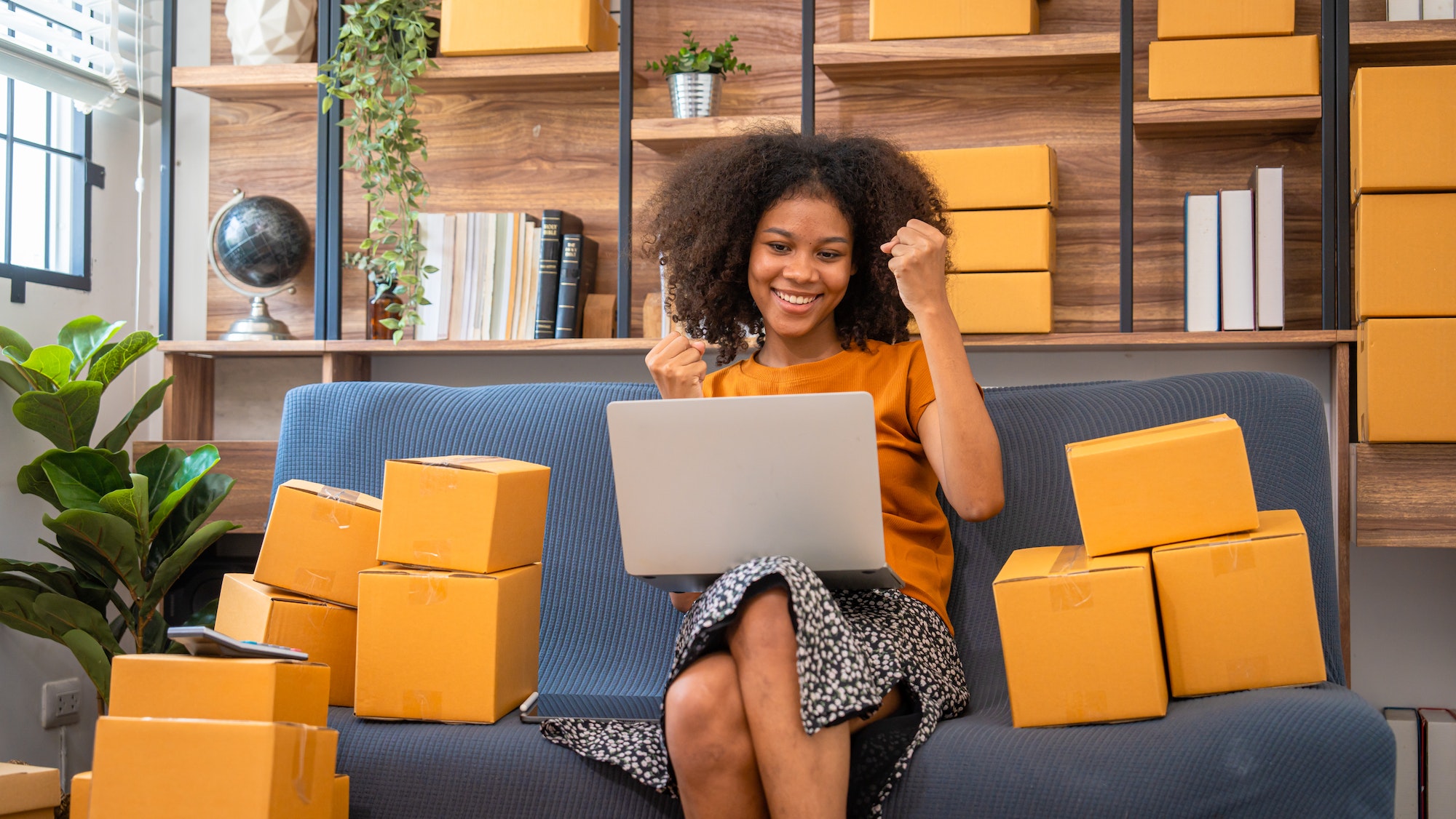 African American business woman working at warehouse preparing SME package box for delivery