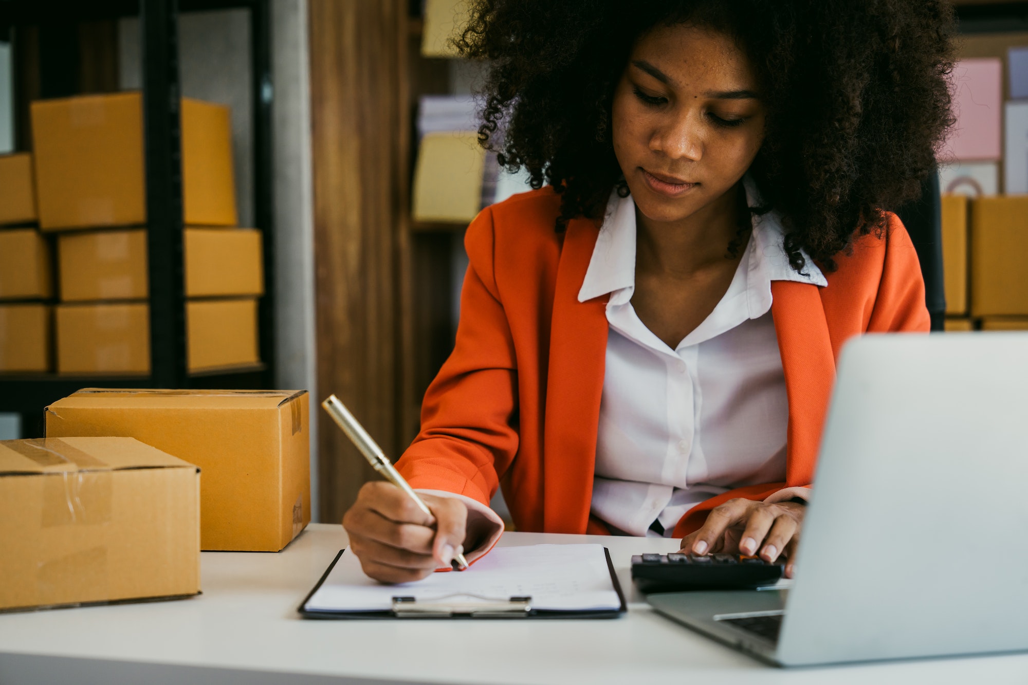 African American business woman working at warehouse preparing SME package box for delivery